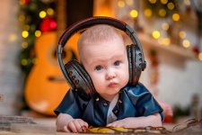 cute-little-baby-is-lying-his-tummy-with-headphones-listening-music_127093-1289.jpg