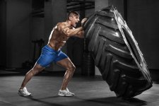 Muscular-man-working-out-in-gym-flipping-tire.jpg